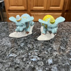 Ceramic Disney Dumbo The Flying Elephant pair of Salt and Pepper Shakers.  Brand new never used.  Has been on display in a cabinet with a very large s