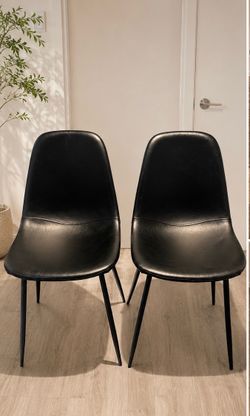 2 black faux leather chairs