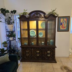 China cabinet with glass shelves and light inside