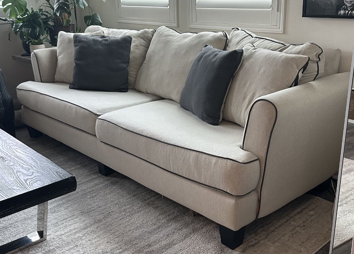 Farmhouse, Contemporary, Modern. 102” beige sofa with reversible accent pillows from Living Spaces