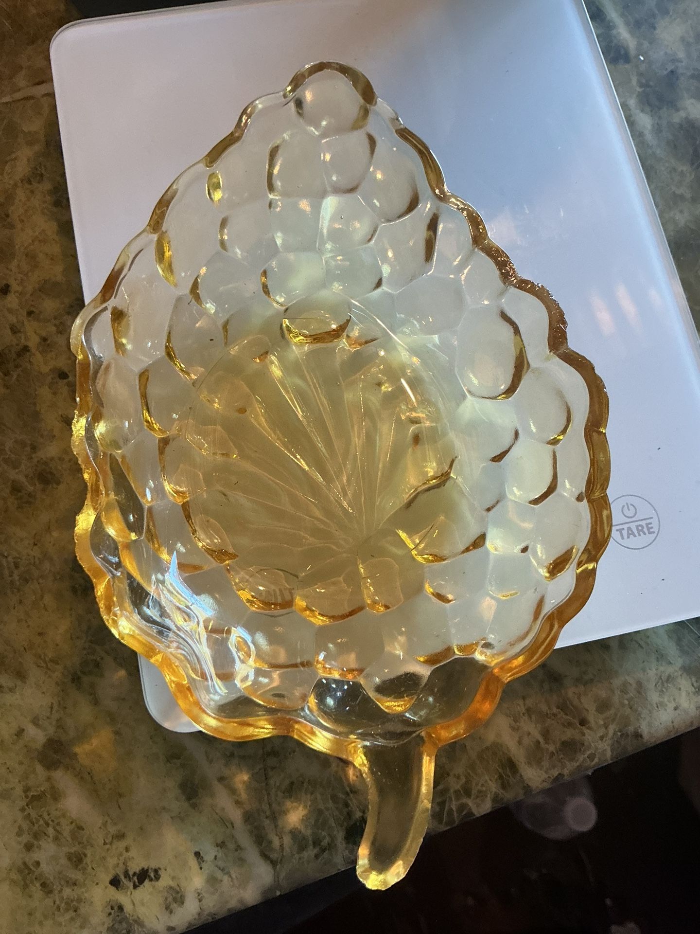 The Vintage Anchor Hocking Yellow Bubble Glass Grape Leaf Candy Nut Dish is a charming 1940s