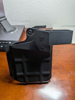 Thumb trigger phone holster