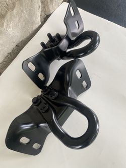 OEM Black front bumper tow hooks with support brackets designed for Ford Trucks.