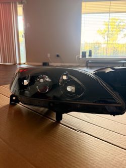 04-09 Mazda sedan headlights driver and passenger