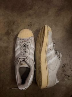 white and grey Adidas Superstar sneakers