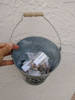 Metal bucket with paper confetti packs. Gold and white