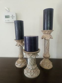 Set of three candles holders with candles