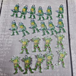 21 Teenage Mutant Ninja Turtles charms 12 of Leonardo in the blue bandana 9 of Raphael in the red bandana use them as keychains bag charms for parties