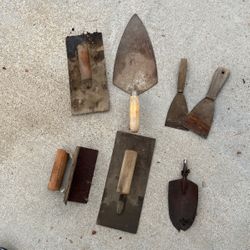 Collection of mortar, trowels, spackling tools