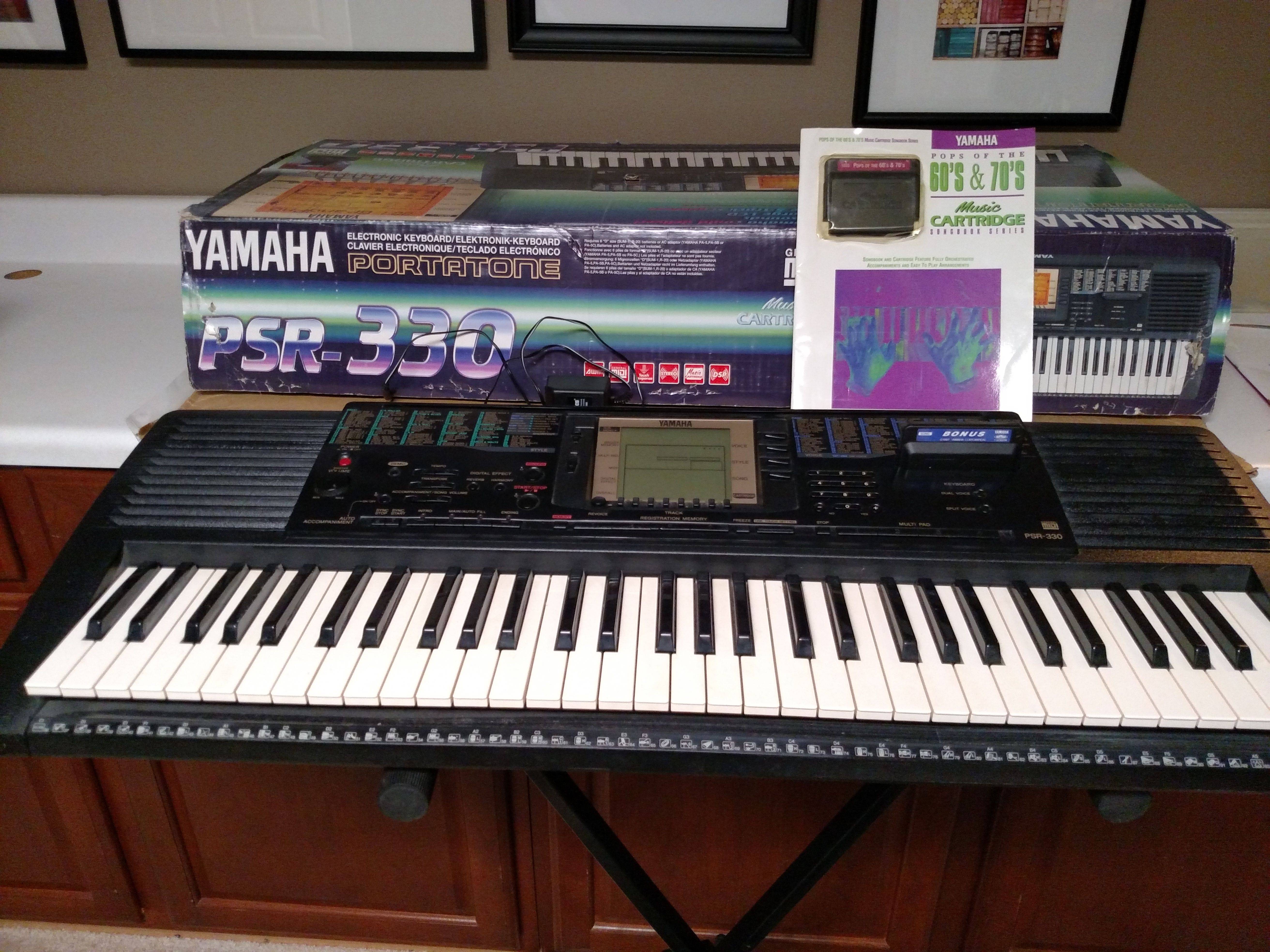 Yamaha PSR 330 keyboard, stand, power cord and music book with cassette