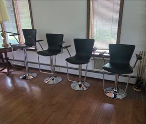 Adjustable black faux leather bar stools with chrome metal
