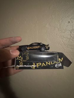 This is a 1:64 scale Model Model Pandem Mustang diecast car in black with gold graphics.