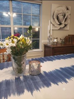 Multi-tiered silver candelabra Staggered column lengths Tiered visual effect