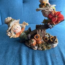 Girl And Boy Scarecrows Playing On A Working Teeter Totter