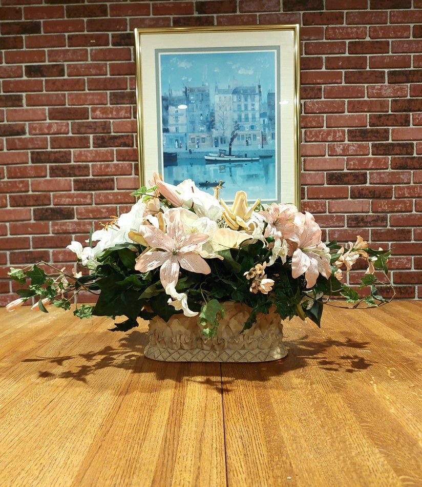 Floral arrangement in an oval roman type ceramic pot