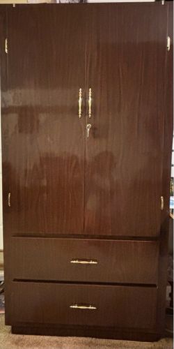 large vintage wooden armoire/chifforobe, with two upper doors and two large drawers.