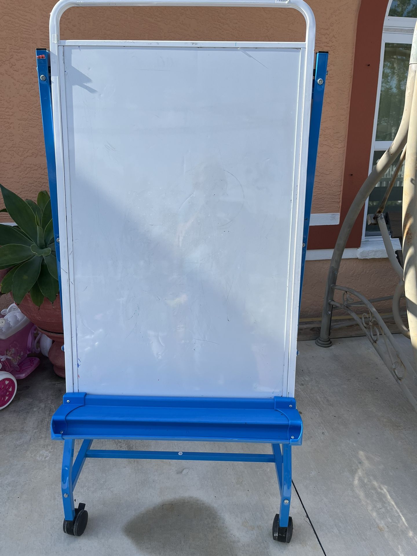 Blackboard in good condition with 4 wheels for transport and the metal frame is like new. It measures 60 inches high and 27 inches wide.