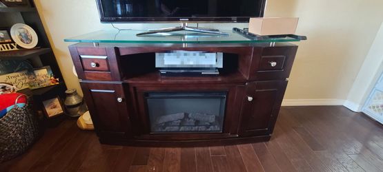 Entertainment center with built in electric heater/fireplace.