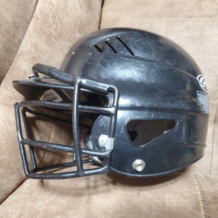 Used black Rawlings baseball helmet with face cage