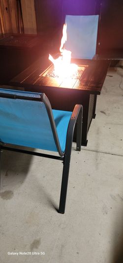 Propane fire pit , with 2 new outdoor chairs firm price