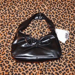 Black leather shoulder bag with bow detail