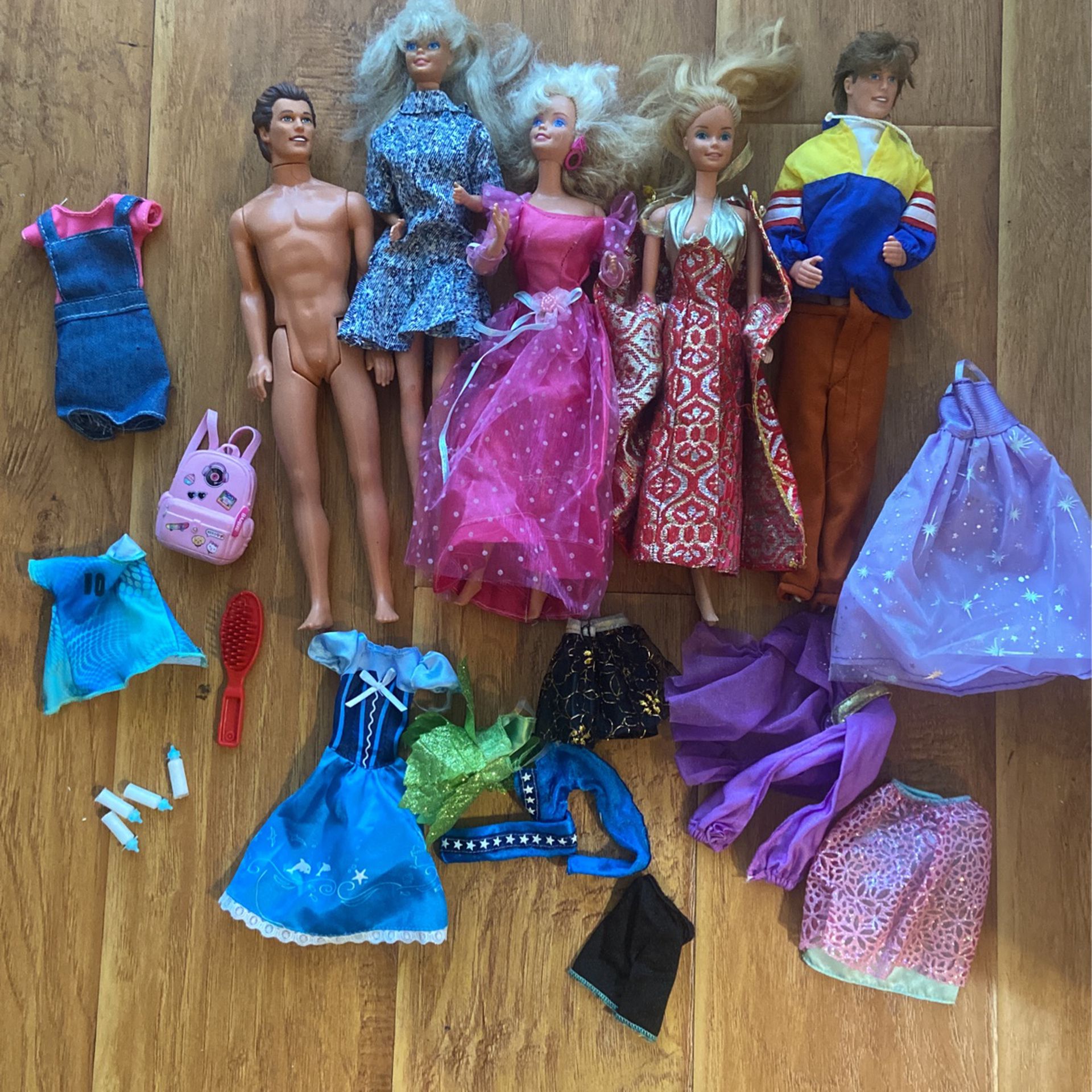 barbie dolls and two ken and clothes