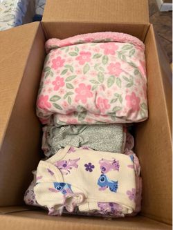 Box of baby clothes