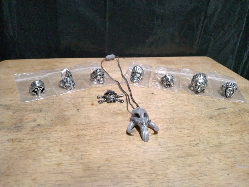 7 Unisex Stainless Steel Gothic Biker Rings Size 8. Plus A Silver Tone Miniature Pirate Skull 💀 Pendant. And A Star Wars Mandalorian Skull Necklace.