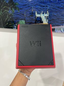 Selling a Wii Mini console in like-new condition, including cables and 4 games.