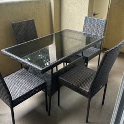 Outdoor wicker and glass top table