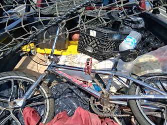 Vintage chrome BMX freestyle bicycle with mag wheels resting in the back of a truck.Product type: 20-inch freestyle BMX bike, resembling models like a