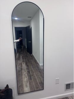 Black framed arched mirror