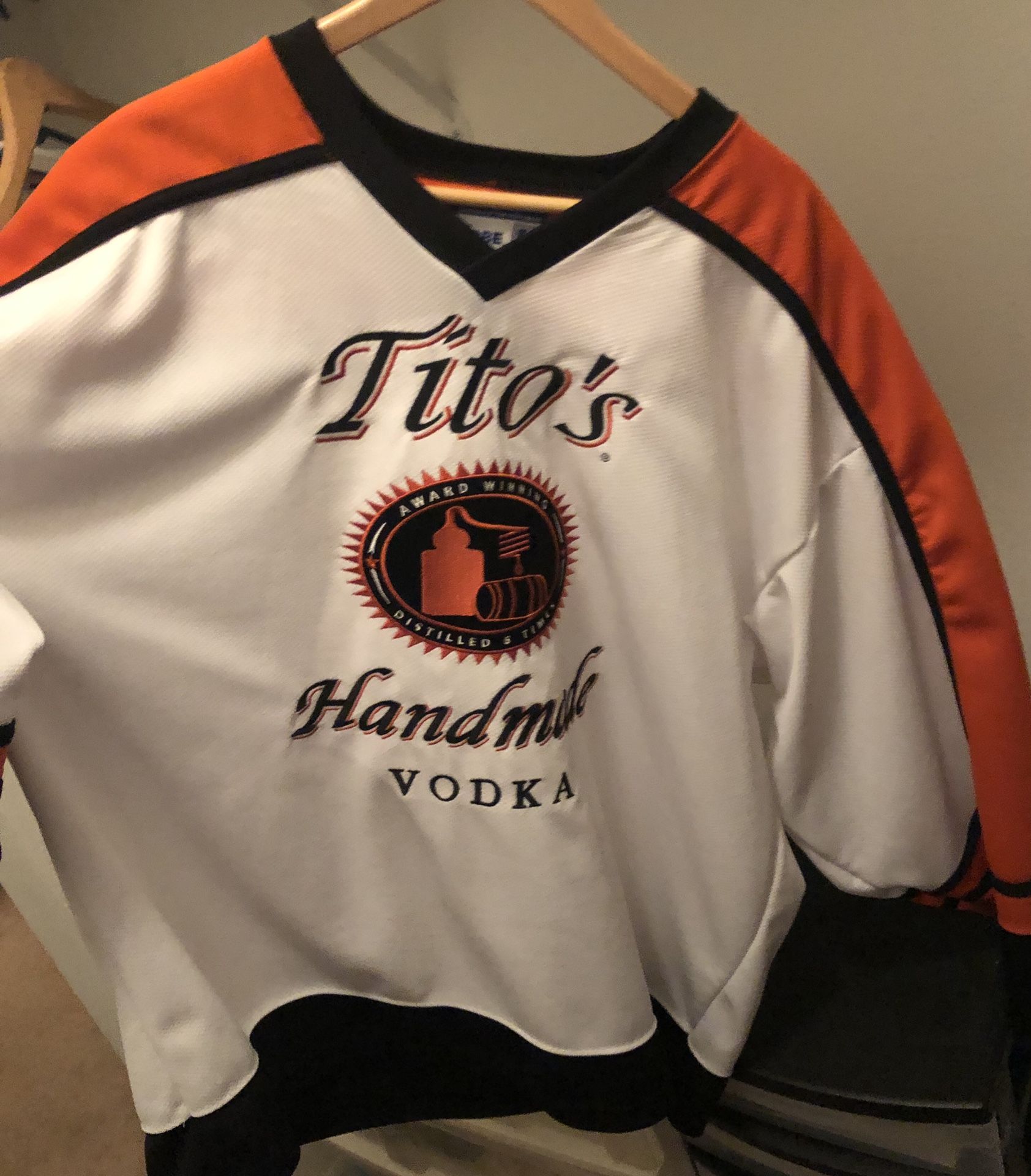 Tito’s vodka , hockey jersey, man cave