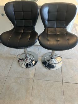 2 adjustable black bar stools