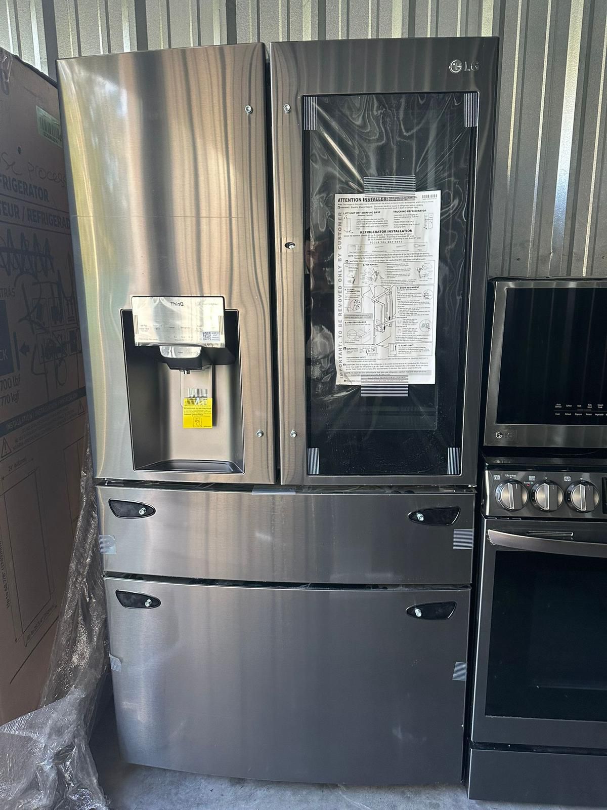 New LG black stainless steel 4-door 36-inch refrigerator with water and ice dispenser