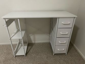 White desk with drawers and book shelf