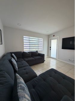Dark Gray Sectional Sofa with Tufted Cushions