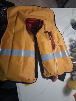 Durable Revere Supply Co. inflatable life vest, model 61018. This adult universal personal flotation device is yellow with reflective strips and a red