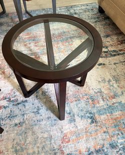 Round glass top table with interlocking X-shape legs