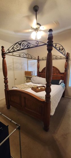 Queen size wooden poster bed with rod iron