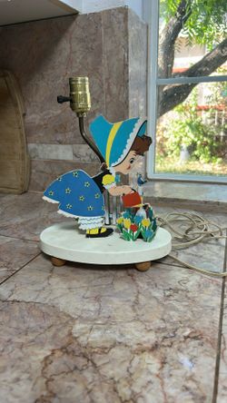 Antique little girl in the gardening lamp