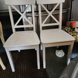 Two wood  white chairs 