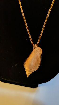 Gold sea shell necklace on a 14" chain