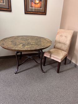 Round marble table and upholstered chair