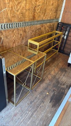 Two mirror, top metal and glass side tables and one glass table with three shelves