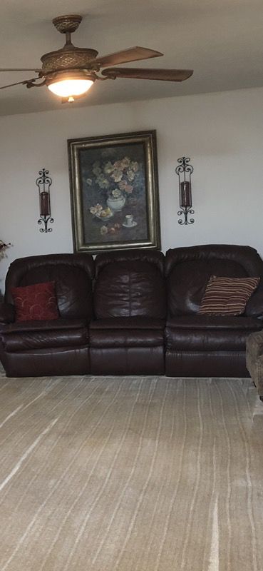 Leather couch with recliners, loveseat and coffee table.