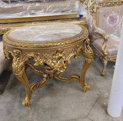  Baroque Revival Table LOOK UP A Baroque revival marble-top occasional table with a gold-gilt carved wooden base. TIME PERIOD Late 19th Century ORIGIN