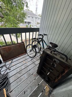 Two bicycles and one gas flattop outside cooking sale as is