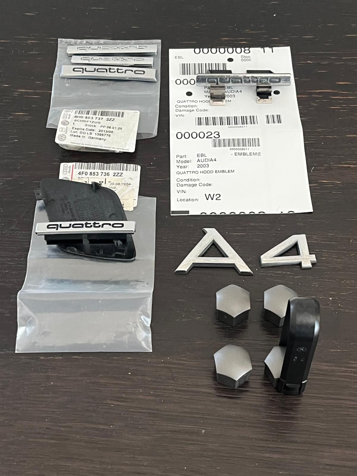 OEM Audi A4 Quattro emblems and 4 wheel nut covers