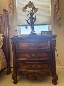 Ornate Wood Nightstand with Three Drawers